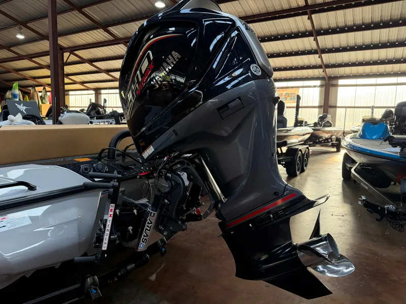 Slide: The Image of A powerful outboard motor on a modern boat in a warehouse setting. - 2