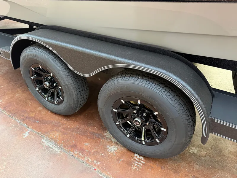 Slide: The Image of Close-up of a boat trailer with two black tires and sleek rims. - 21