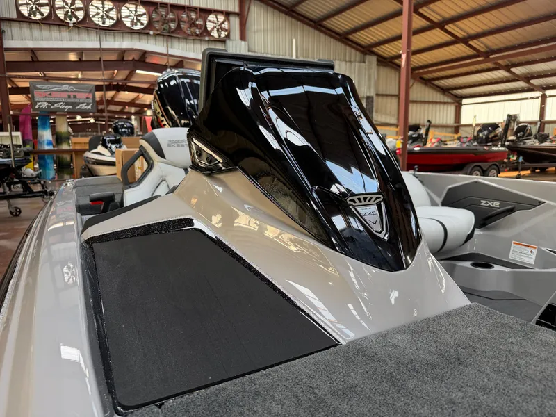 Slide: The Image of The image shows a modern boat with a sleek black engine cover in a warehouse setting. - 4