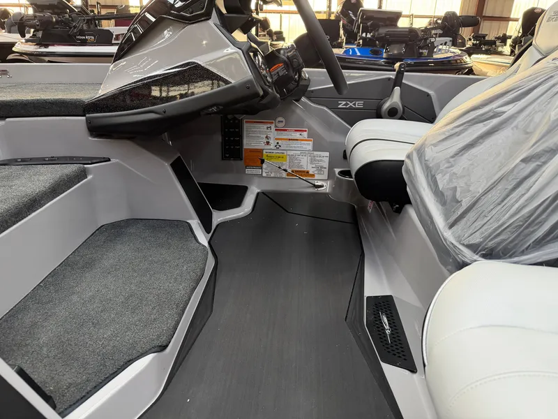 Slide: The Image of The image shows the cockpit of a 2027 Skeeter ZXE20 boat with modern seating and controls. - 12