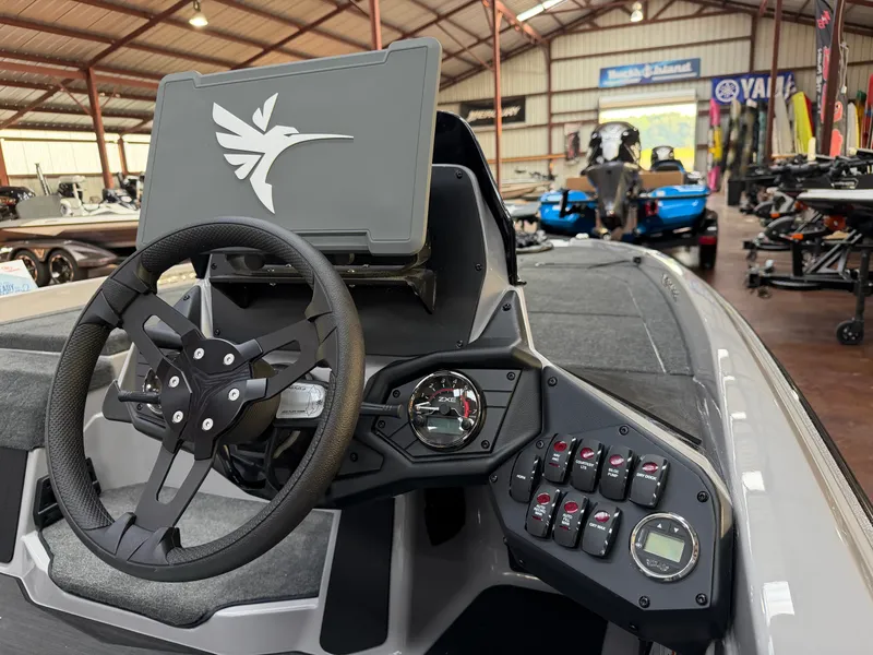 Slide: The Image of The image shows the cockpit of a 2027 Skeeter ZXE20 boat with a modern steering wheel and dashboard. - 13