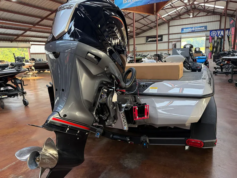 Slide: The Image of A gray boat with a powerful outboard motor is situated in a warehouse. - 18