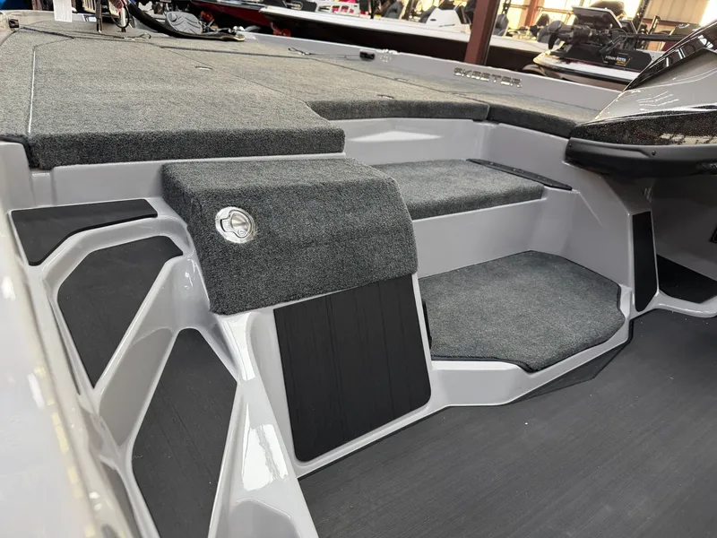 Slide: The Image of The image shows the interior of a 2027 Skeeter ZXE20 boat with gray carpeting. - 11