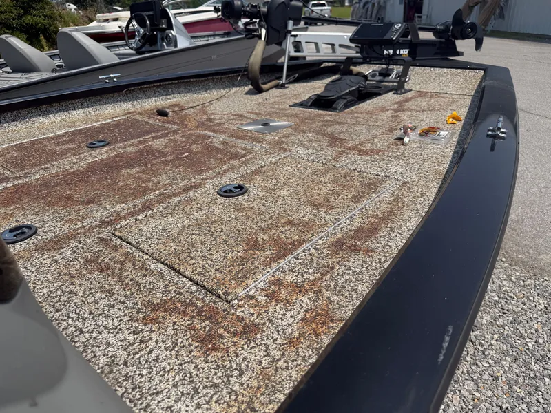 Slide: The Image of The image shows the deck of a 2015 Tracker Pro Team 175 TXW boat with fishing gear. - 8