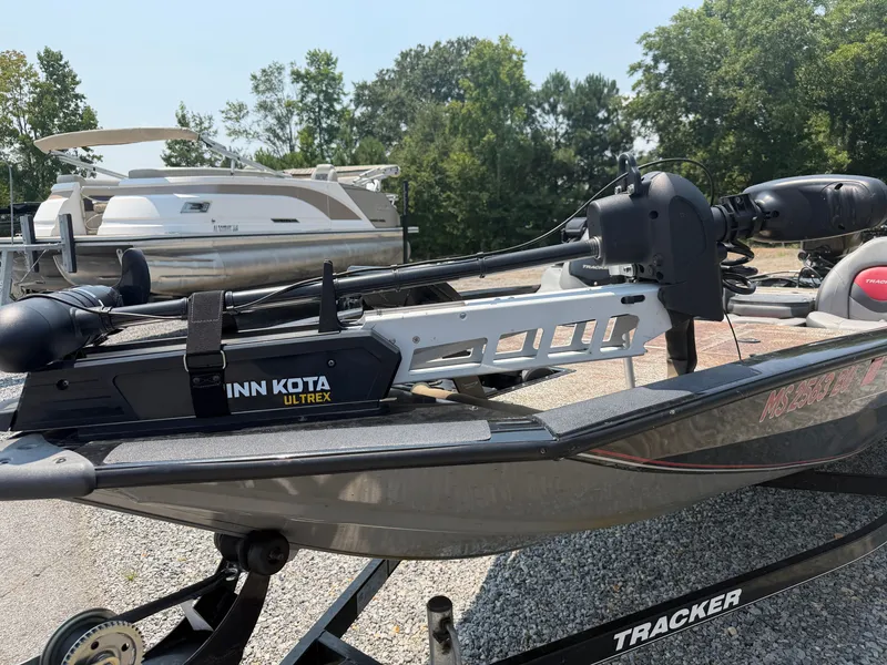 Slide: The Image of A Tracker Pro Team 175 TXW boat with a Minn Kota Ultrex motor, parked on a trailer. - 10