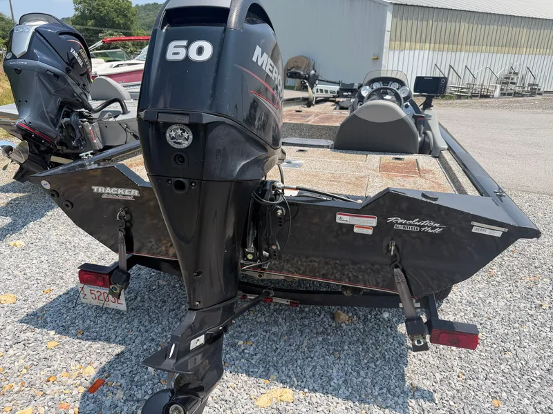 Slide: The Image of A 2015 Tracker Pro Team 175 TXW with a 60 HP engine, parked on a gravel lot. - 4