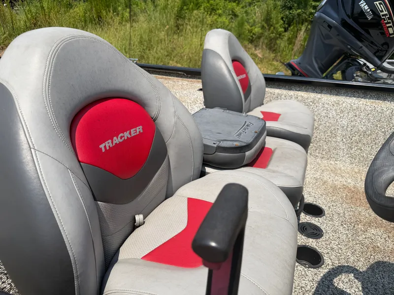 Slide: The Image of The 2015 Tracker Pro Team 175 TXW features gray and red seats with an outboard motor. - 7