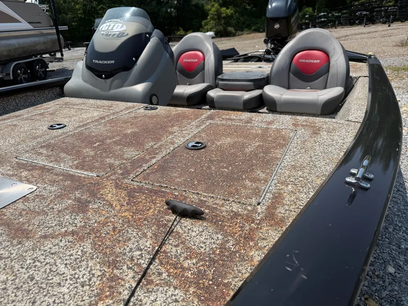 Slide: The Image of A 2015 Tracker Pro Team 175 TXW with a worn deck and two gray seats. - 12
