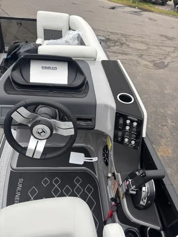 Slide: The Image of The image shows the cockpit of a 2027 Harris SUNLINER 230 SLDH with a modern helm. - 12