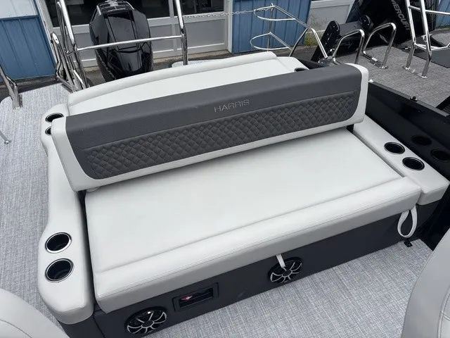 Slide: The Image of The image shows a luxurious bench seat on a Harris SUNLINER 230 SLDH boat. - 13