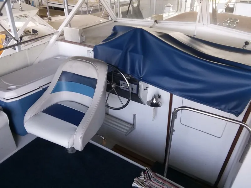 Slide: The Image of The image shows the cockpit of a 1979 Chris-Craft 350 Catalina with a blue seat. - 20