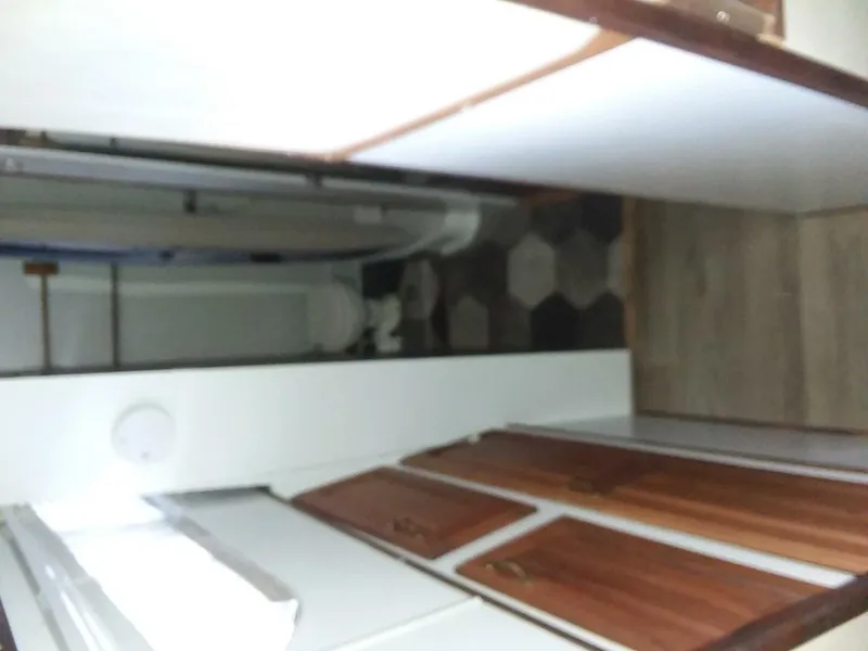 Slide: The Image of Interior of a 1979 Chris-Craft 350 Catalina with wooden doors and a small bathroom. - 17