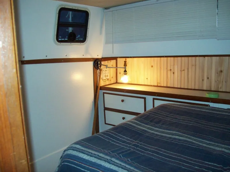 Slide: The Image of Interior of a 1979 Chris-Craft 350 Catalina with wood paneling and a bed. - 9