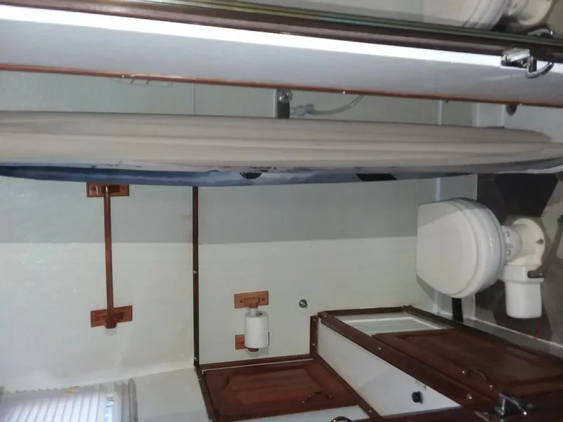 Slide: The Image of The image shows a boat bathroom with a toilet, sink, and shower. - 13