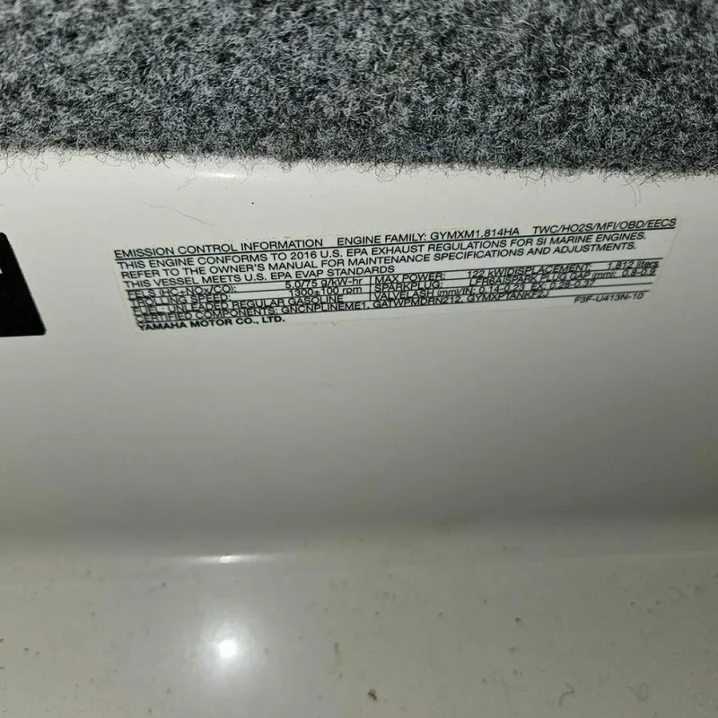 Slide: The Image of Close-up of an emissions sticker on a Yamaha boat. - 13