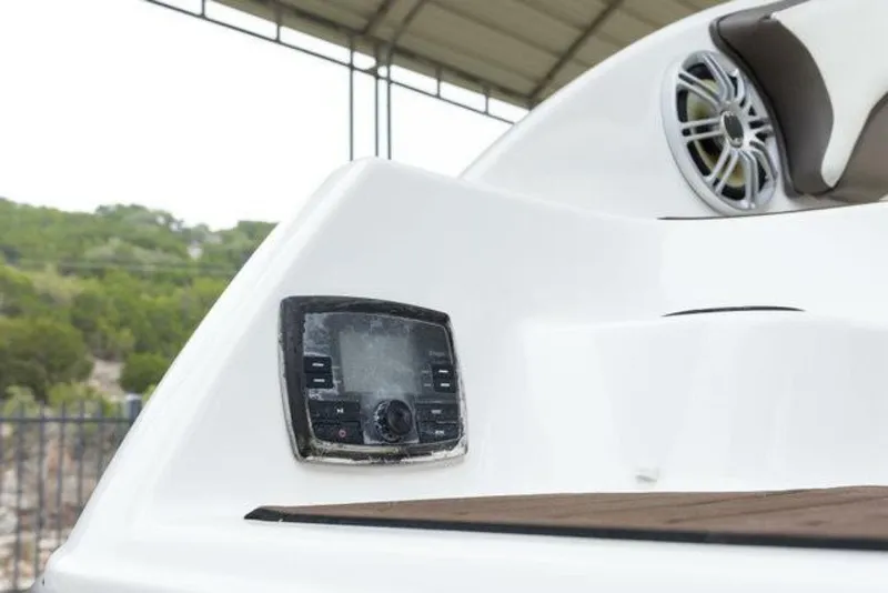 Slide: The Image of Close-up of a boat deck with speaker and control unit, surrounded by green landscape. - 48