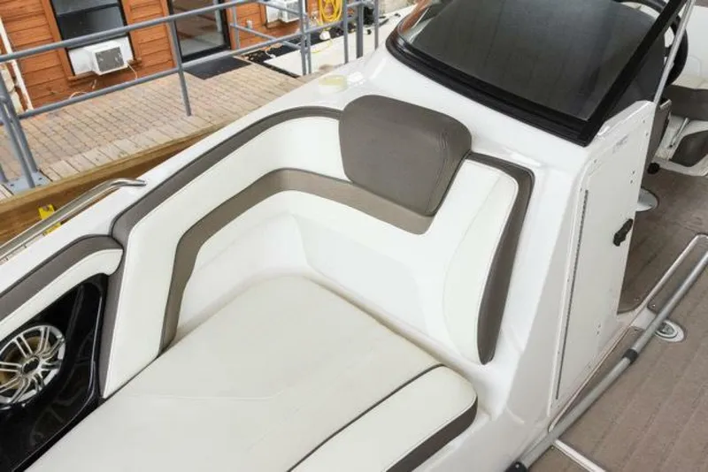 Slide: The Image of The image shows the cockpit of a 2016 Yamaha 242 Limited S E-Series boat with cushioned seating. - 34