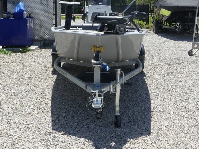 Slide: The Image of A 2026 Tracker Bass Tracker Classic CC on a trailer, parked on a gravel lot. - 8