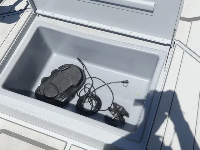 Slide: The Image of An open storage compartment on a 2026 Tracker Bass Tracker Classic CC boat with cables and accessories. - 20