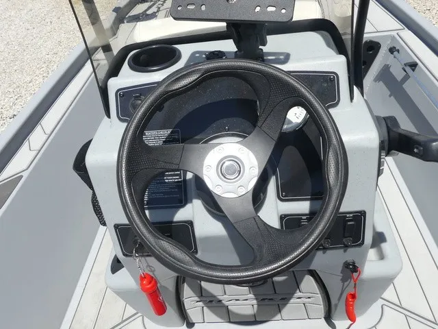Slide: The Image of The image shows the steering wheel of a 2026 Tracker Bass Tracker Classic CC boat. - 18
