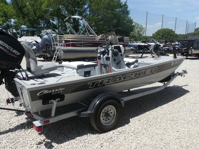 Slide: The Image of A 2026 Tracker Bass Tracker Classic CC on a trailer, surrounded by other boats. - 6