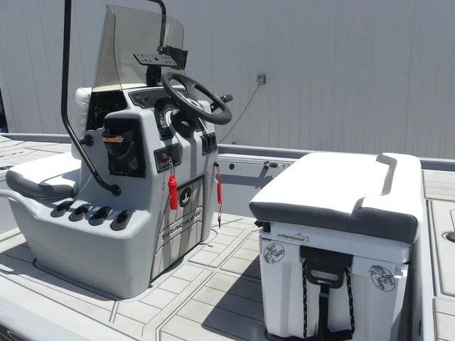 Slide: The Image of The image shows the cockpit of a 2026 Tracker Bass Tracker Classic CC with a steering console and bench. - 11