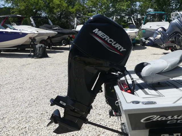 Slide: The Image of A Mercury outboard motor is mounted on a Tracker Bass Tracker Classic CC boat, surrounded by other boats. - 17