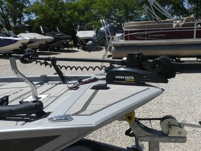 Slide: The Image of A boat with a Minn Kota trolling motor on a trailer, surrounded by other boats. - 22