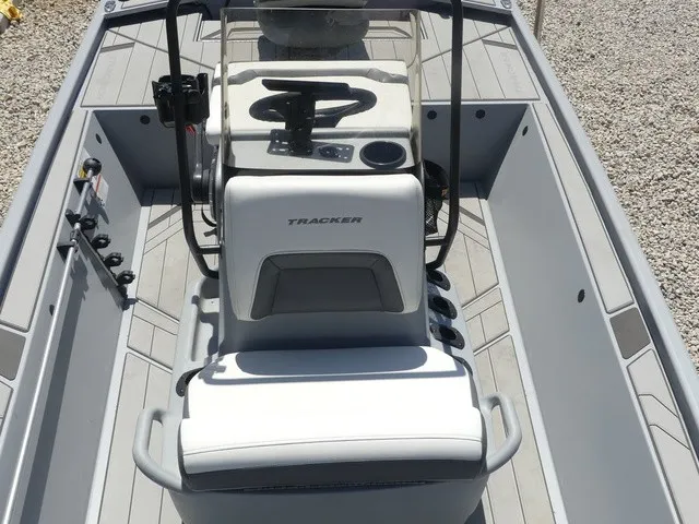 Slide: The Image of The image shows the cockpit of a 2026 Tracker Bass Tracker Classic CC boat with gray seats and a steering console. - 21