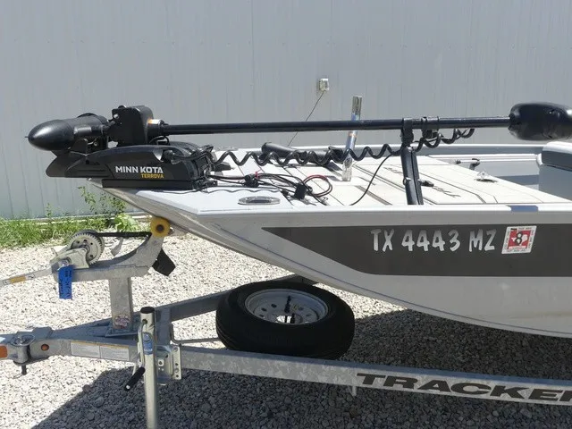 Slide: The Image of A gray boat on a trailer with Minn Kota motor and registration number TX 4443 MZ. - 23