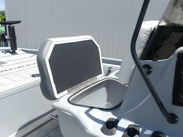 Slide: The Image of A gray seat with a black backrest on a boat, surrounded by console and fishing gear. - 13