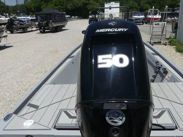 Slide: The Image of A Mercury 50 outboard motor is mounted on a Tracker Bass Tracker Classic CC boat on a gravel lot. - 14