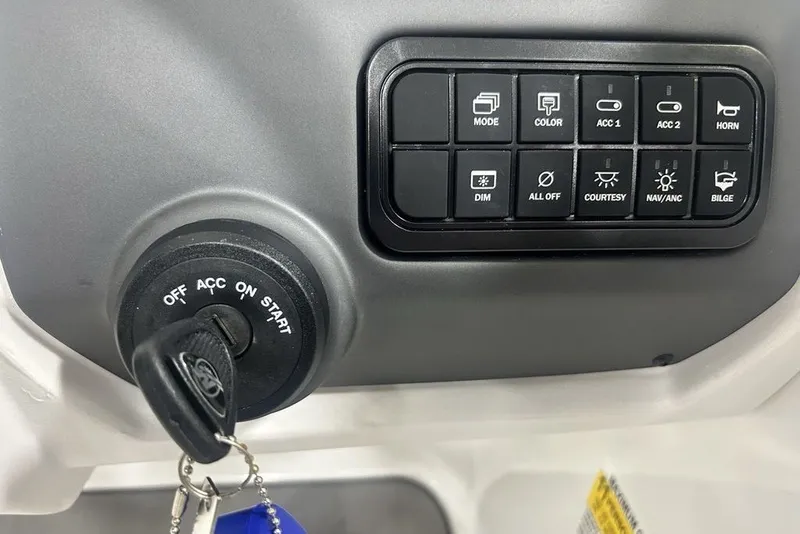 Slide: The Image of Dashboard controls and ignition of a 2026 Tahoe T21 boat, featuring various function buttons. - 27