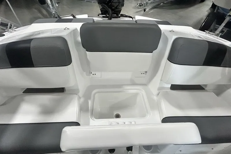 Slide: The Image of 2026 Tahoe T21 boat interior with gray and white seating and storage compartment. - 12