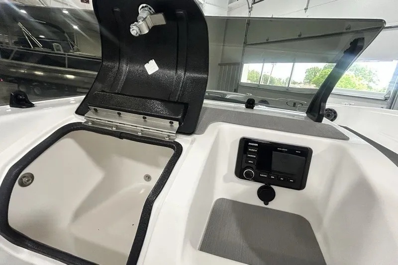 Slide: The Image of 2026 Tahoe T21 boat interior with storage compartment and control panel. - 13