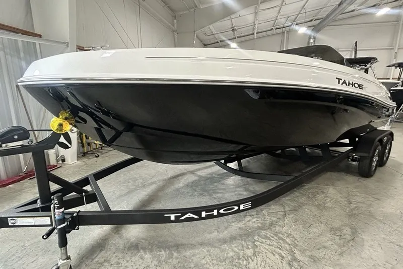 Slide: The Image of 2026 Tahoe T21 boat on trailer in indoor showroom setting. - 6