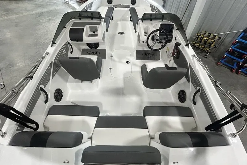 Slide: The Image of 2026 Tahoe T21 boat interior with modern seating and steering console in a showroom. - 24