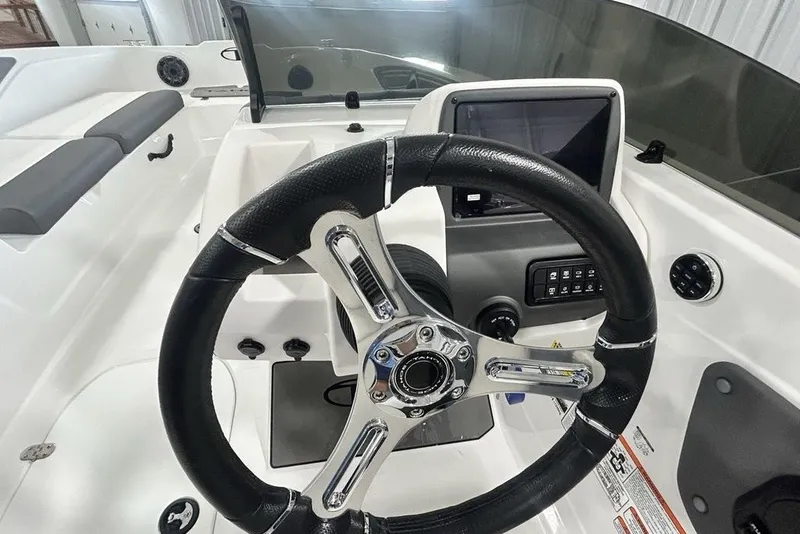 Slide: The Image of 2026 Tahoe T21 boat dashboard with steering wheel and control panel. - 11