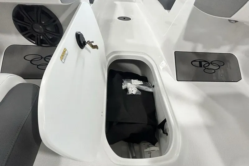 Slide: The Image of Open storage compartment in 2026 Tahoe T21 boat, featuring sleek design and secure lock. - 23