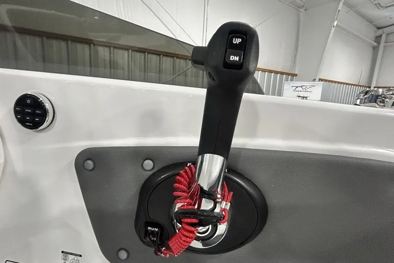 Slide: The Image of Throttle control lever on a 2026 Tahoe T21 boat dashboard. - 21