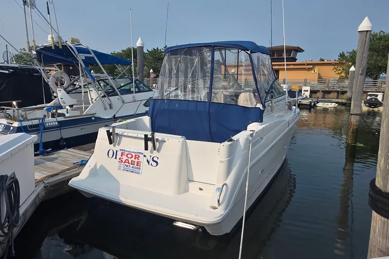 Slide: The Image of 1998 Bayliner 2655 Ciera boat for sale, docked in marina with blue canopy. - 22