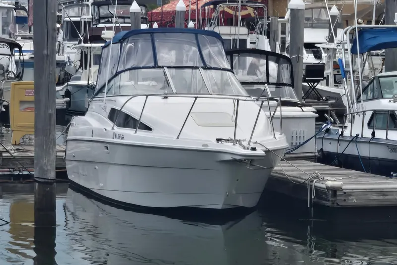 Slide: The Image of 1998 Bayliner 2655 Ciera docked at a marina, surrounded by other boats. - 3