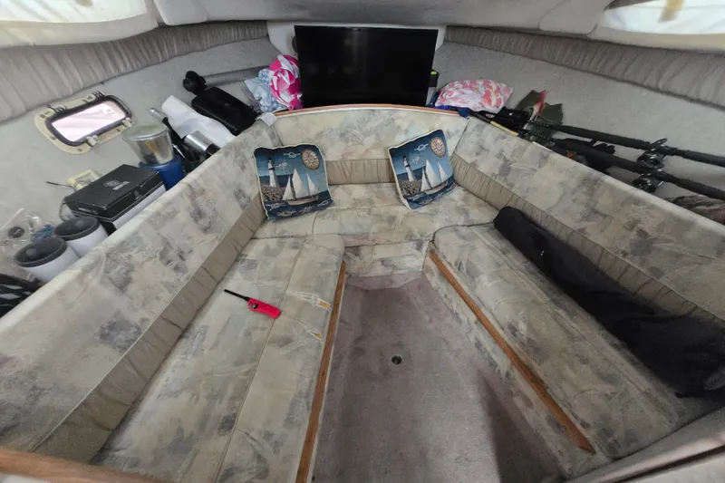 Slide: The Image of Interior of a 1998 Bayliner 2655 Ciera boat with cozy seating and nautical decor. - 16