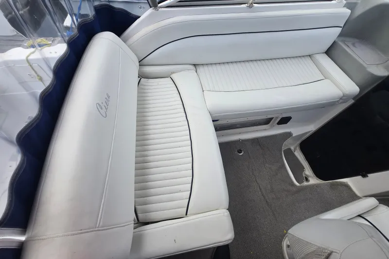 Slide: The Image of Interior seating of a 1998 Bayliner 2655 Ciera boat, featuring white upholstery. - 12