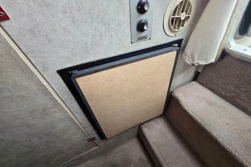 Slide: The Image of Interior of 1998 Bayliner 2655 Ciera showing a compact fridge and control panel. - 5