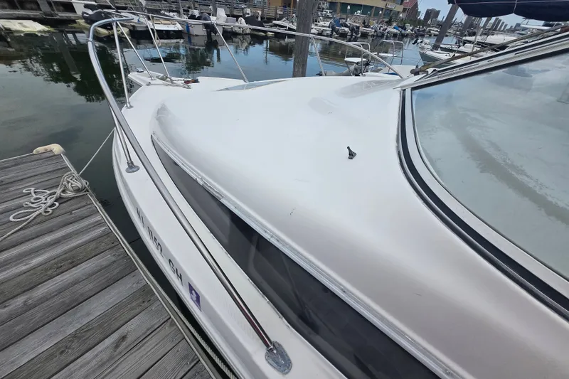 Slide: The Image of 1998 Bayliner 2655 Ciera docked at marina, showcasing sleek design and spacious deck. - 10