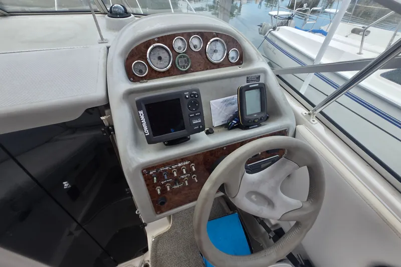 Slide: The Image of 1998 Bayliner 2655 Ciera boat dashboard with steering wheel and navigation instruments. - 7