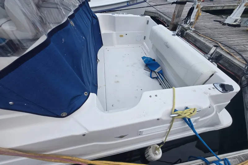 Slide: The Image of 1998 Bayliner 2655 Ciera boat docked, featuring a spacious cockpit with blue cover. - 6
