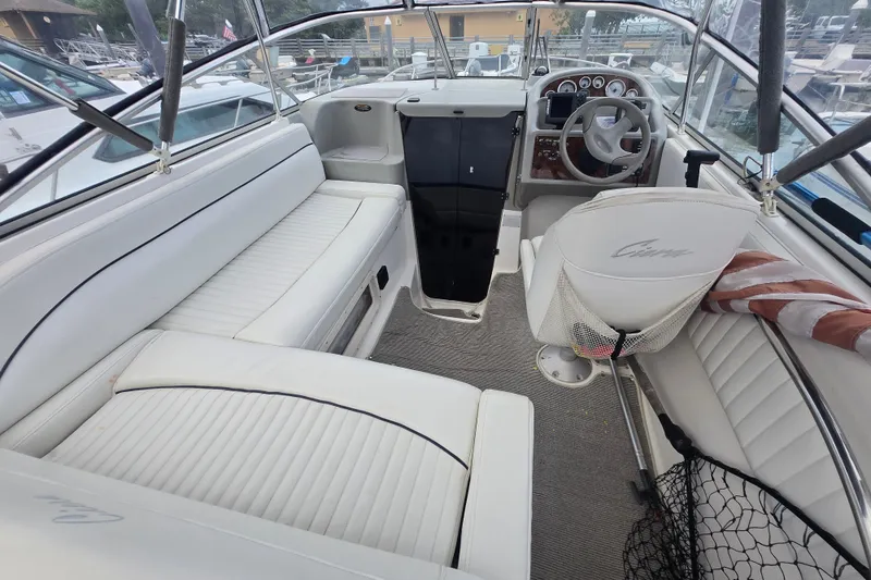 Slide: The Image of 1998 Bayliner 2655 Ciera boat interior with white seating and steering wheel. - 11