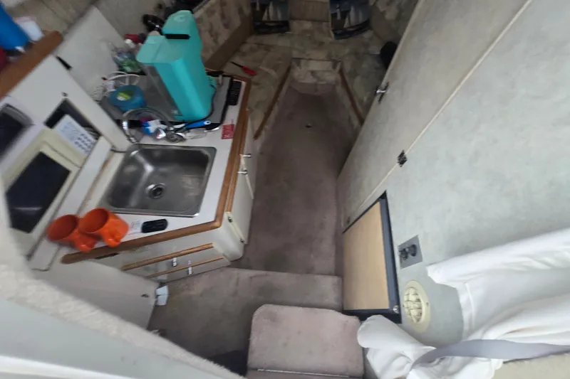 Slide: The Image of Interior of 1998 Bayliner 2655 Ciera boat with kitchenette and seating area. - 15
